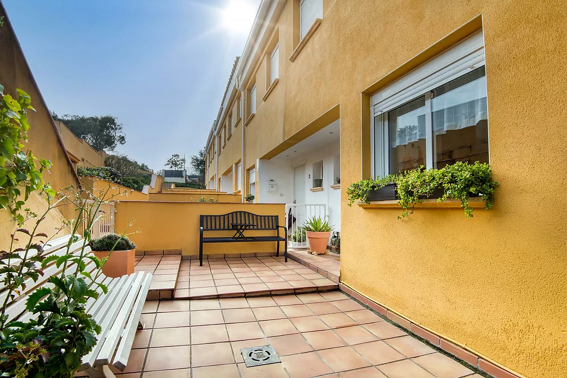 Corner townhouse with a communal pool.