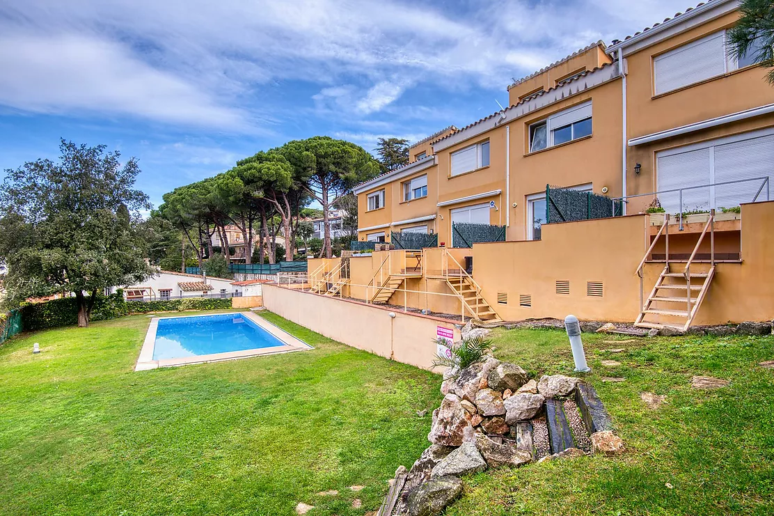 Corner townhouse with a communal pool.