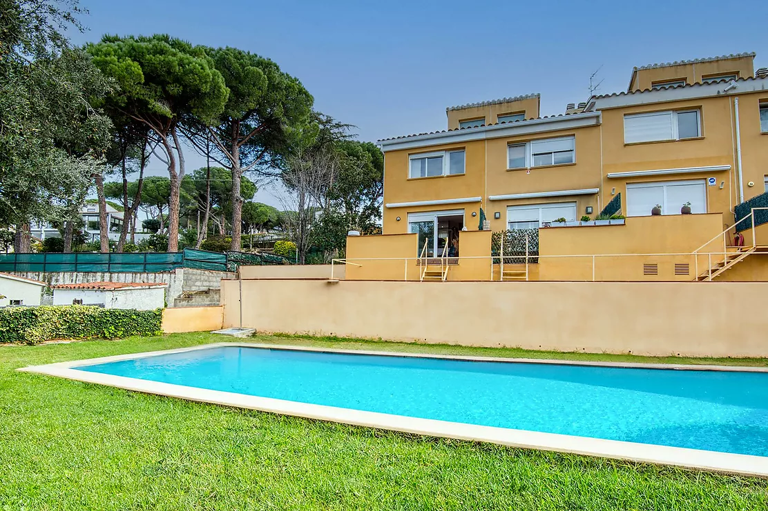 Corner townhouse with a communal pool.